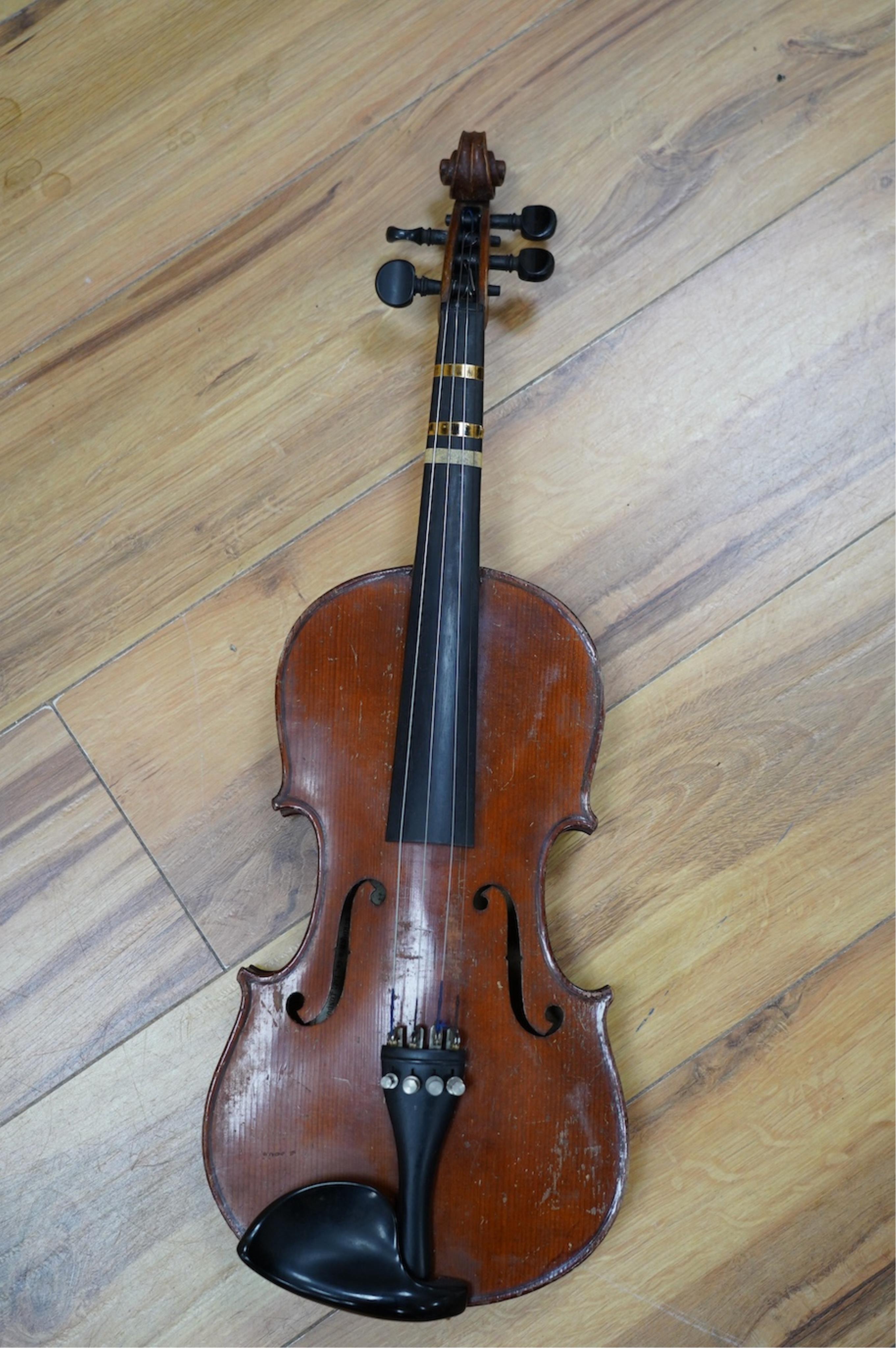 Two late 19th or early 20th century violins, one with case, back of largest measures 36cm. Condition - poor to fair